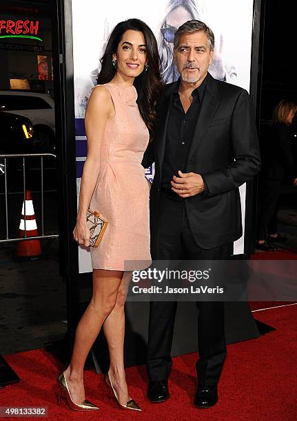 Amal Clooney and George Clooney attend the premiere of "Our Brand Is Crisis" at TCL Chinese Theatre on October 26, 2015 in Hollywood, California.