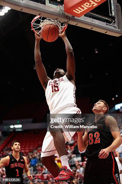 Junior Longrus of the Washington State Cougars dunks against Justin Smith of the Idaho State Bengals in the first half at Beasley Coliseum on...