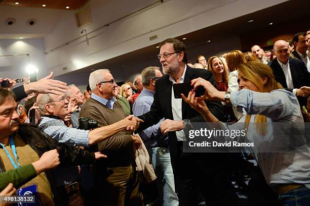 Spain's Prime Minister and President of Partido Popular Mariano Rajoy shakes hands with supporters during the official presentation of the Partido...