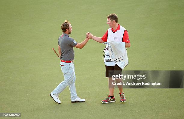 Andy Sullivan of England celebrates with his caddie Sean Mcdonagh after his par on the 18th holeduring the third round of the DP World Tour...