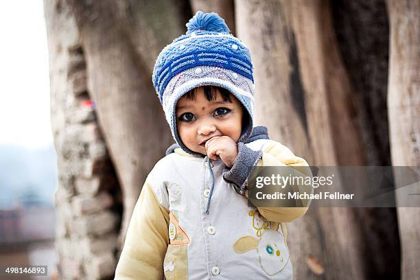 young nepali girl in bhaktapur in winter clothes - michael virtue stock pictures, royalty-free photos & images