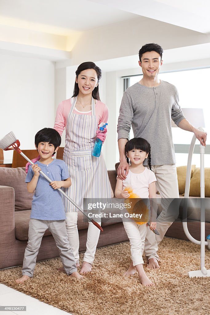 Cheerful family doing chores at home