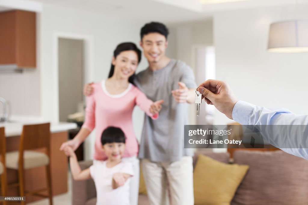 Real estate agent giving family key