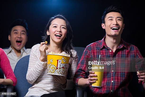 young couple watching movie in cinema - asian cinema stock pictures, royalty-free photos & images