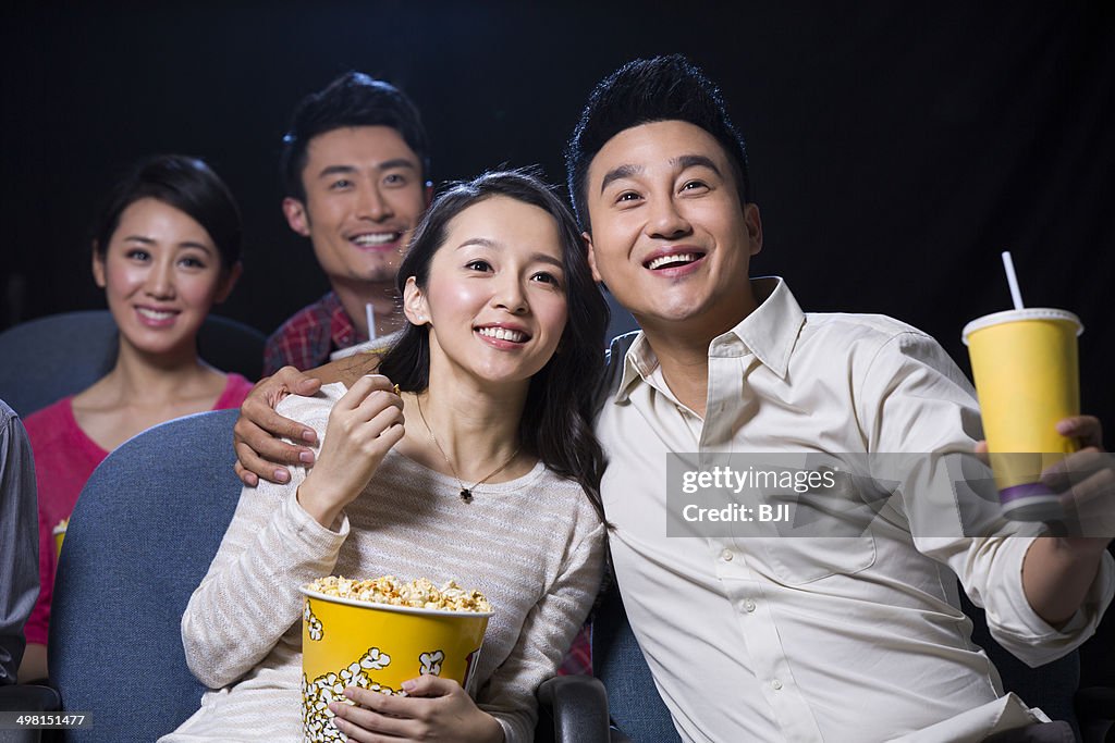 Young couple watching movie in cinema