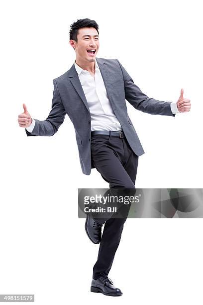 fashionable businessman doing thumbs up - modischer anzug stock-fotos und bilder