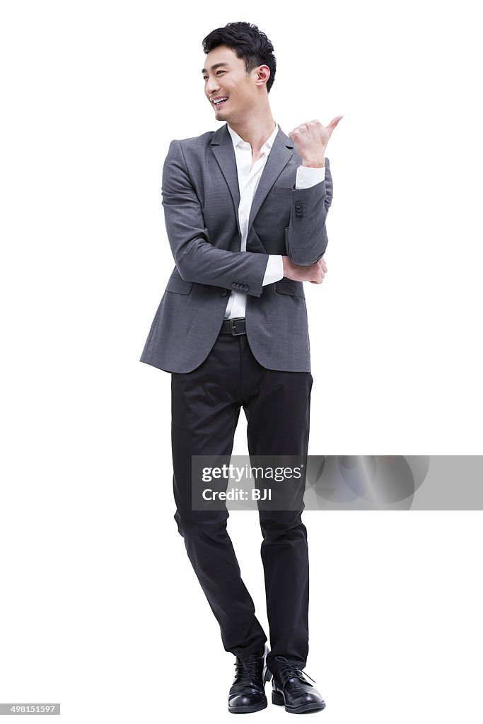 Fashionable businessman pointing away