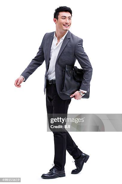 fashionable businessman on the move - business man walking with a bag in asia bildbanksfoton och bilder