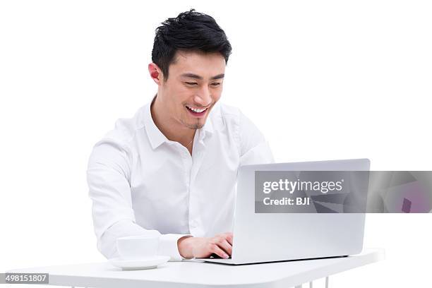 young businessman using laptop - chinese people at work stock pictures, royalty-free photos & images
