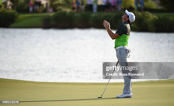 Rory McIlroy of Northern Ireland reacts to his birdie outt on the par three 17th hole during the third round of the DP World Tour Championship on the...