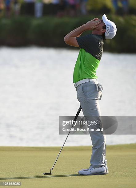 Rory McIlroy of Northern Ireland reacts to his birdie outt on the par three 17th hole during the third round of the DP World Tour Championship on the...