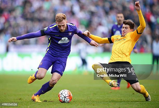 Max Wegner of Aue and Jim-Patrick Mueller of Dresden compete for the ball during the Third League match between Erzgebirge Aue and Dynamo Dresden at...
