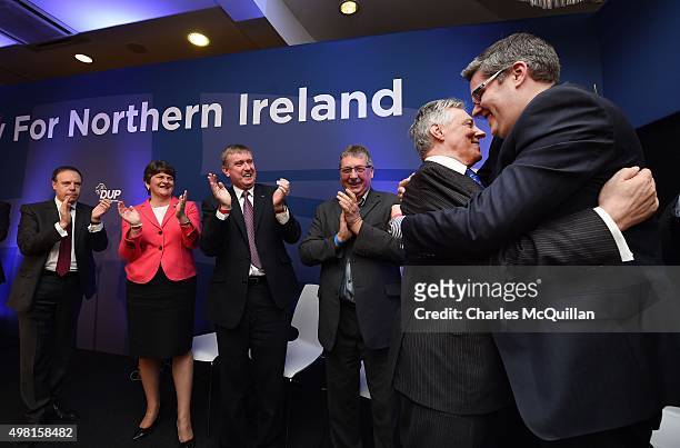 Peter Robinson is embraced by Gavin Robinson as he makes his exit from the Democratic Unionist Party annual conference at La Mon Hotel on November...