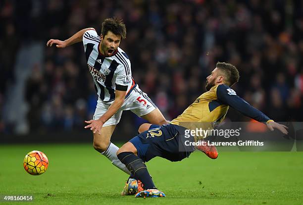 Claudio Yacob of West Bromwich Albion is tackled by Olivier Giroud of Arsenal during the Barclays Premier League match between West Bromwich Albion...