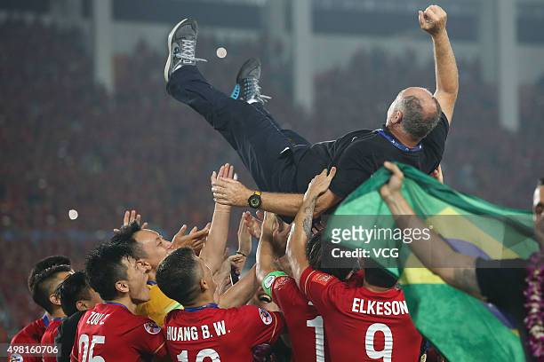 Luiz Felipe Scolari, head coach of Guangzhou Evergrande, is thrown in the air by his players as they celebrate after winning the second leg of the...