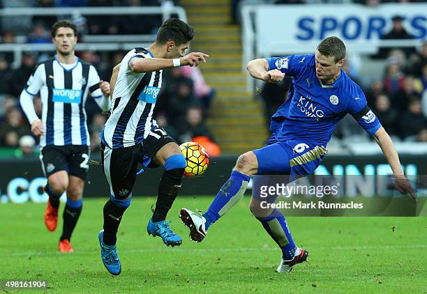 Ayoze Perez of Newcastle is tackled by Robert Huth of Leicester during the Barclays Premier League match between Newcastle United FC and Leicester...