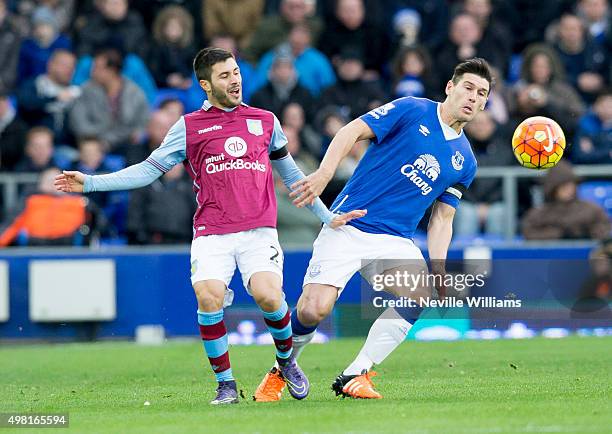 Carles Gil of Aston Villa is challenged by Gareth Barry of Everton during the Barclays Premier League match between Everton and Aston Villa at...