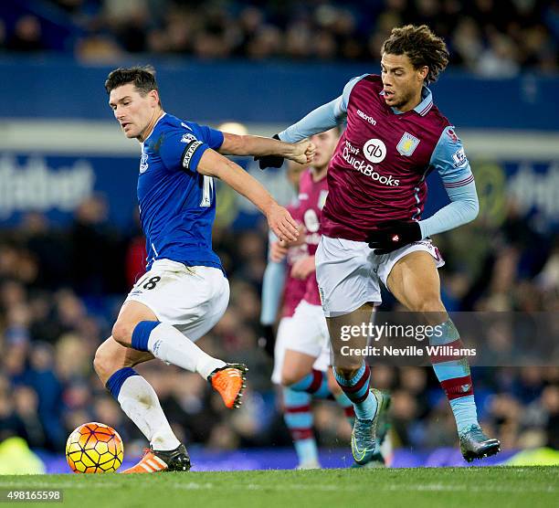 Rudy Gestede of Aston Villa is challenged by Gareth Barry of Everton during the Barclays Premier League match between Everton and Aston Villa at...