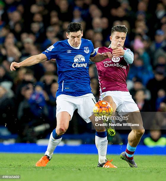Jack Grealish of Aston Villa is challenged by Gareth Barry of Everton during the Barclays Premier League match between Everton and Aston Villa at...