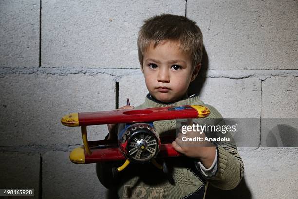 Syrian refugee kid fled from his home due to civil war is seen at a house in Reyhanli district of Hatay on November 21, 2015. Syrian refugee families...