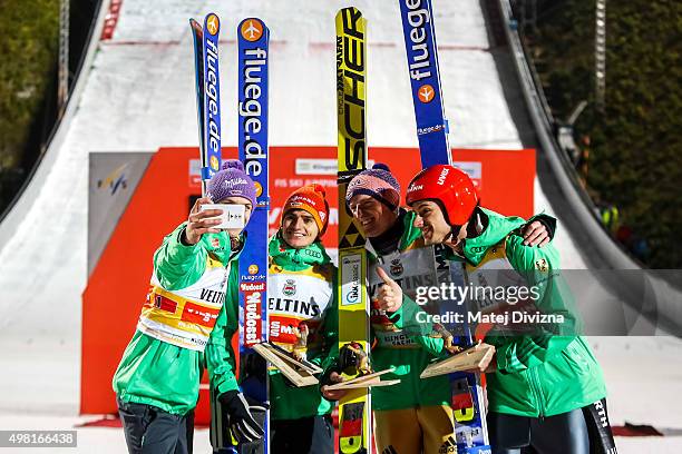 Andreas Wellinger, Richard Freitag, Severin Freund and Andreas Wank from Germany make 'selfie' in front of photographers as they won the team...
