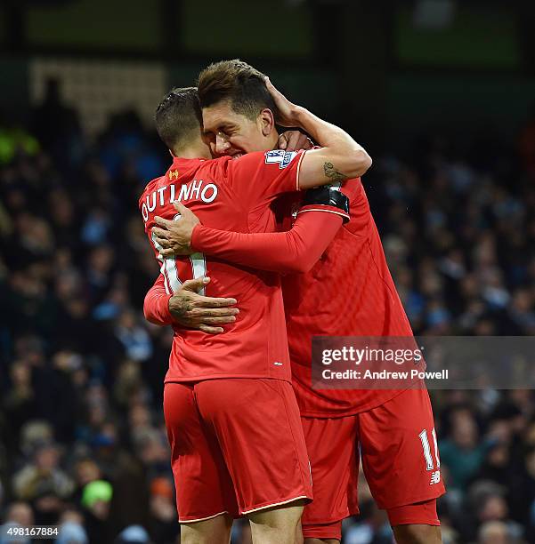 Philippe Coutinho of Liverpool celebrates with Roberto Firmino after scoring the second during the Barclays Premier League match between Manchester...