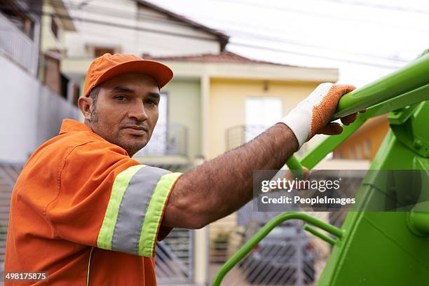 he's keeping our streets clean - vuilnisman stockfoto's en -beelden