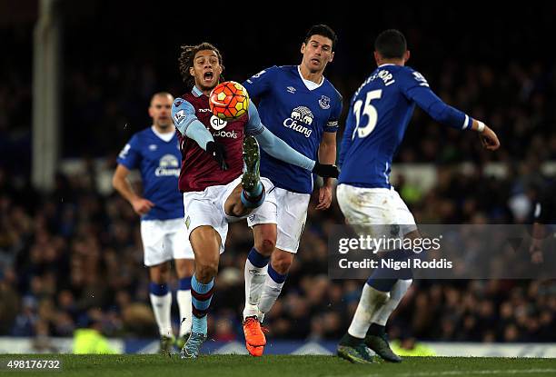 Rudy Gestede of Aston Villa and Gareth Barry of Everton compete for the ball during the Barclays Premier League match between Everton and Aston Villa...