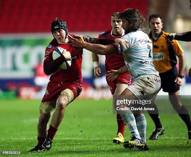 James Davies of Scarlets is collared by Dimitri Szarzewski of Racing 92 during the European Rugby Champions Cup match between Scarlets and Racing 92...