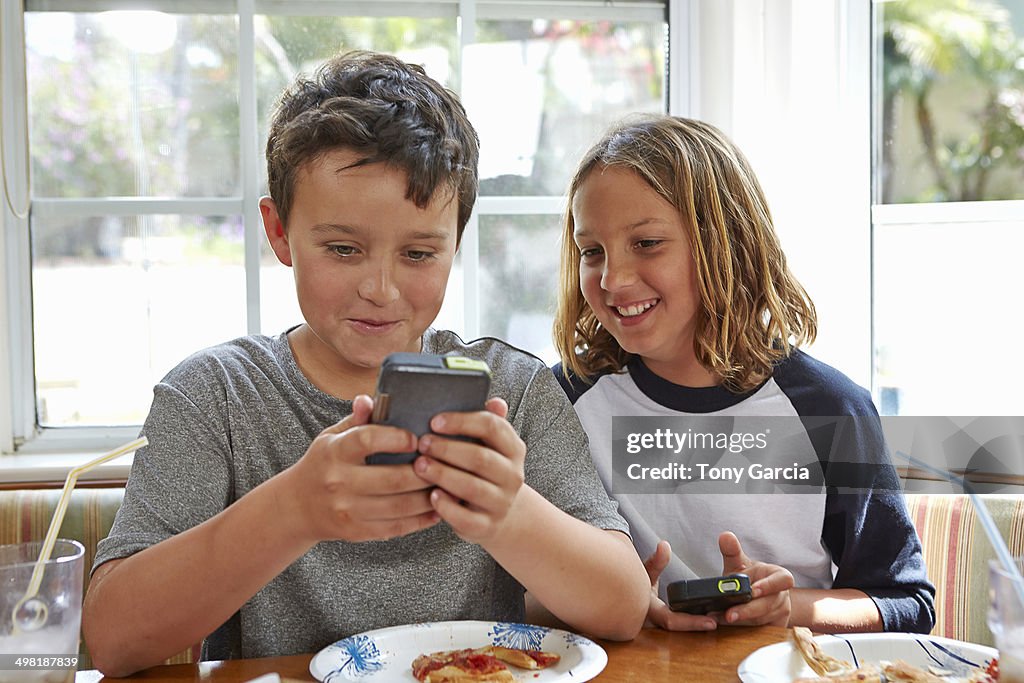 Boys playing handheld video games