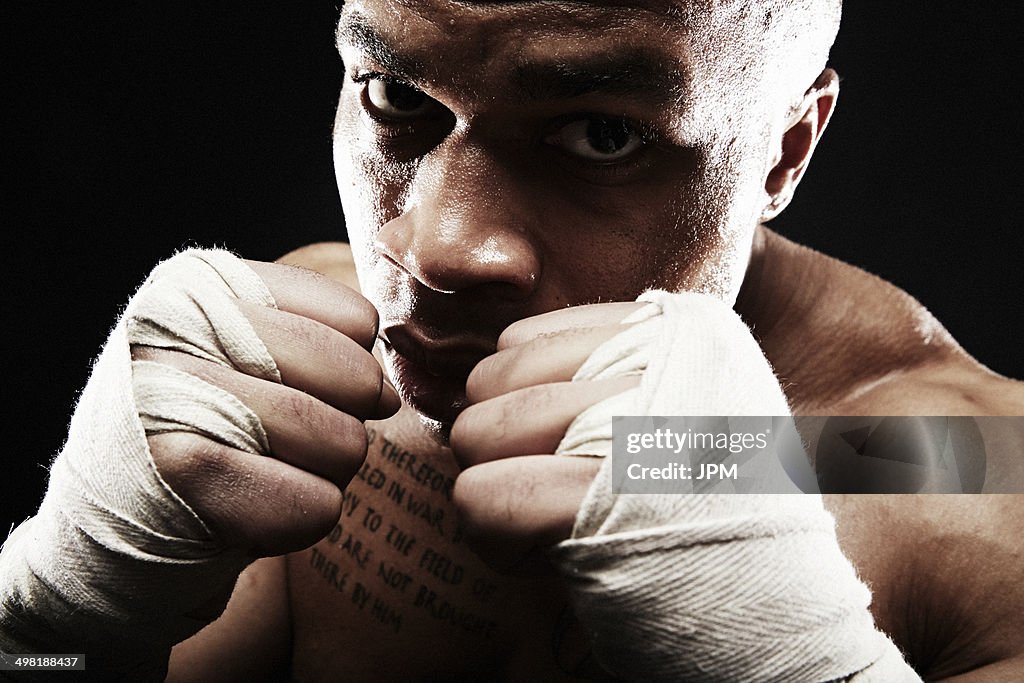 Mid adult man boxing, close up