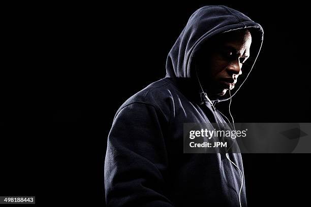 mid adult man wearing hooded top - fighter portraits stock pictures, royalty-free photos & images