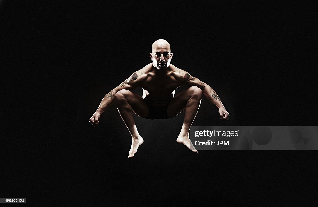Mature man jumping mid air