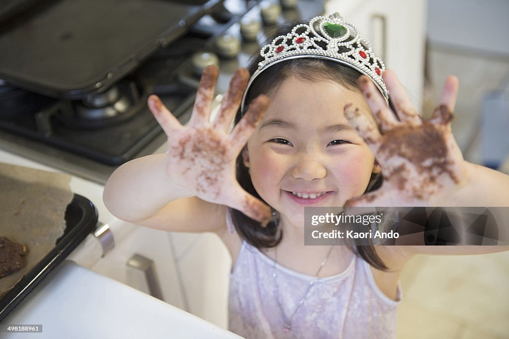 Girl with dirty hands, wearing crown