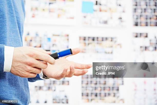 close up of young man holding pen, gesturing - redattore iconografico foto e immagini stock