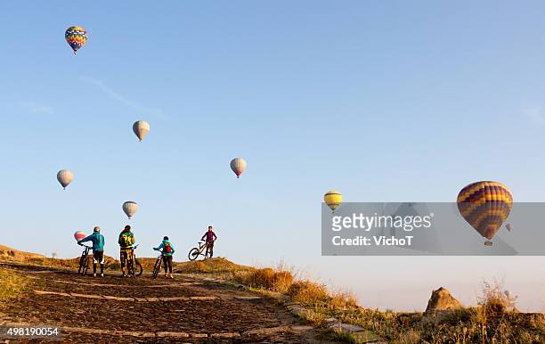 bikes and balloons - hot air balloon ride stock pictures, royalty-free photos & images