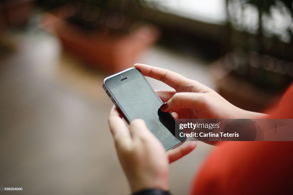 Close up shot of hands using handphone