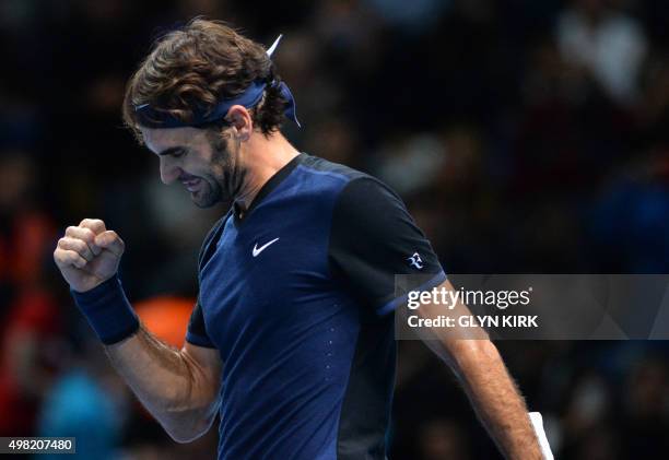 Switzerland's Roger Federer celebrates after beating Switzerland's Stan Wawrinka in a men's singles semi-final match on day seven of the ATP World...