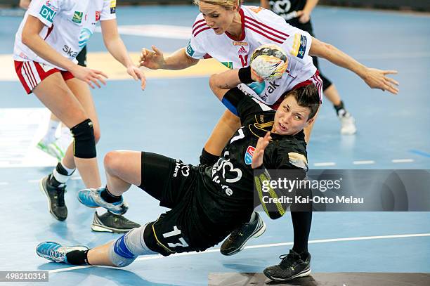 Katarina Jezic makes a shot as Gro Hammerseng-Edin is too late to stop her in the game between Larvik HK and HCM Baia Mare on November 21, 2015 in...