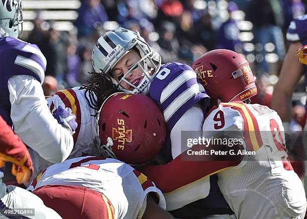 Quarterback Joe Hubener of the Kansas State Wildcats gets tackled by defensive back Reggan Northrup of the Iowa State Cyclones during the second half...