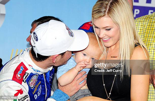 Kyle Larson, driver of the Crest Chevrolet, celebrates in Victory Lane with son Owen and girlfriend Katelyn Sweet after winning during the NASCAR...