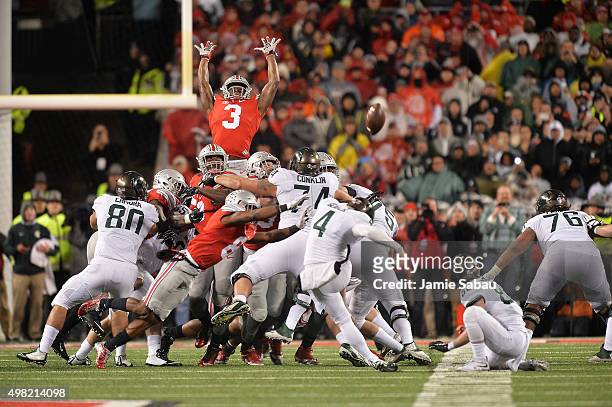 Michael Thomas of the Ohio State Buckeyes goes high to attempt to block a 41-yard field goal attempt by Michael Geiger of the Michigan State Spartans...