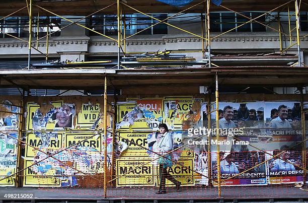Woman walks past Macri signs on November 21, 2015 in Buenos Aires, Argentina. Argentina is facing its first presidential election runoff in the...