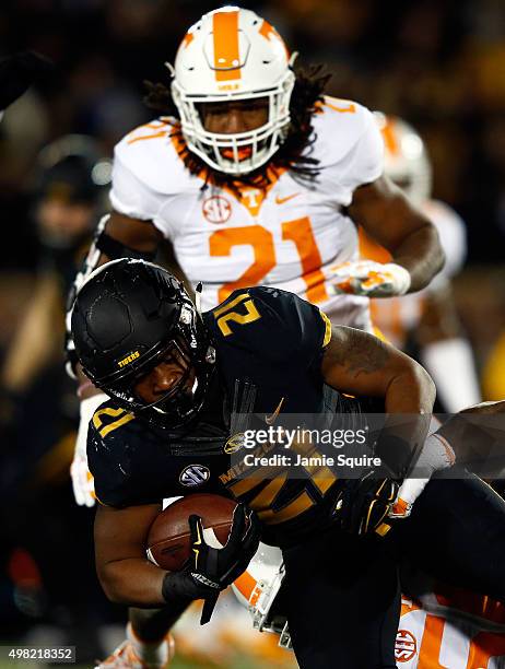 Running back Ish Witter of the Missouri Tigers carries the ball as linebacker Jalen Reeves-Maybin of the Tennessee Volunteers defends during the game...