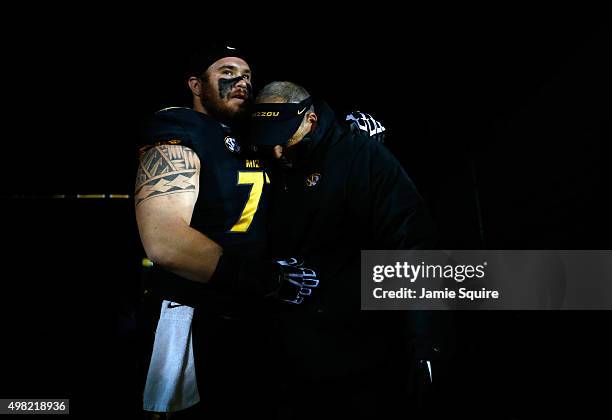 Head coach Gary Pinkel of the Missouri Tigers tears up as he is hugged by offensive lineman Evan Boehm during player introductions for the final time...