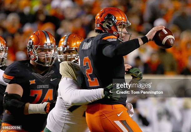 Mason Rudolph of the Oklahoma State Cowboys is sacked by Andrew Billings of the Baylor Bears in the second quarter at Boone Pickens Stadium on...
