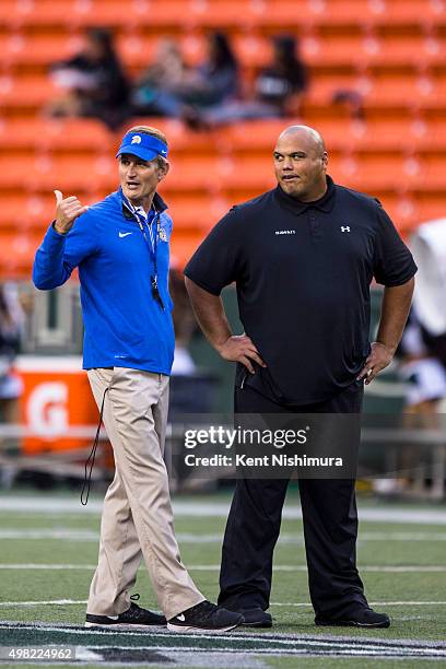 Head coach Ron Caragher of the San Jose State Spartans and interim head coach Chris Naeole of the Hawaii Warriors talk on the field before the start...
