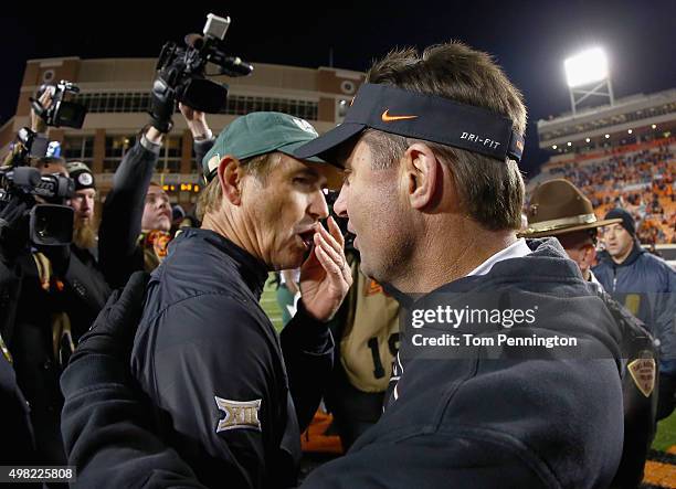 Head coach Art Briles of the Baylor Bears meets head coach Mike Gundy of the Oklahoma State Cowboys on the field after Baylor beat the Oklahoma State...