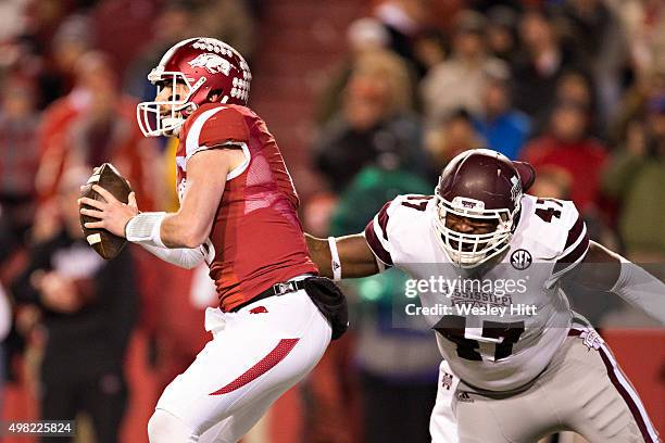 Brandon Allen of the Arkansas Razorbacks avoids the rush of A.J. Jefferson of the Mississippi State Bulldogs at Razorback Stadium Stadium on November...