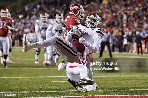 De"Runnya Wilson of the Mississippi State Bulldogs dives into the end zone over Rohan Gaines of the Arkansas Razorbacks at Razorback Stadium Stadium...